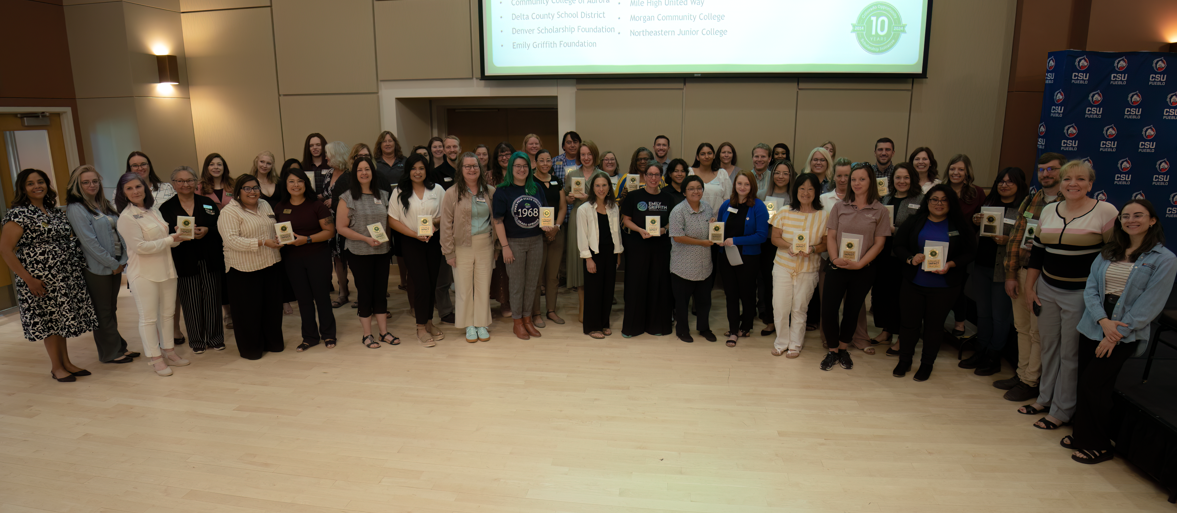 Group of 50 COSI stakeholders with plaques for 10 years of participation